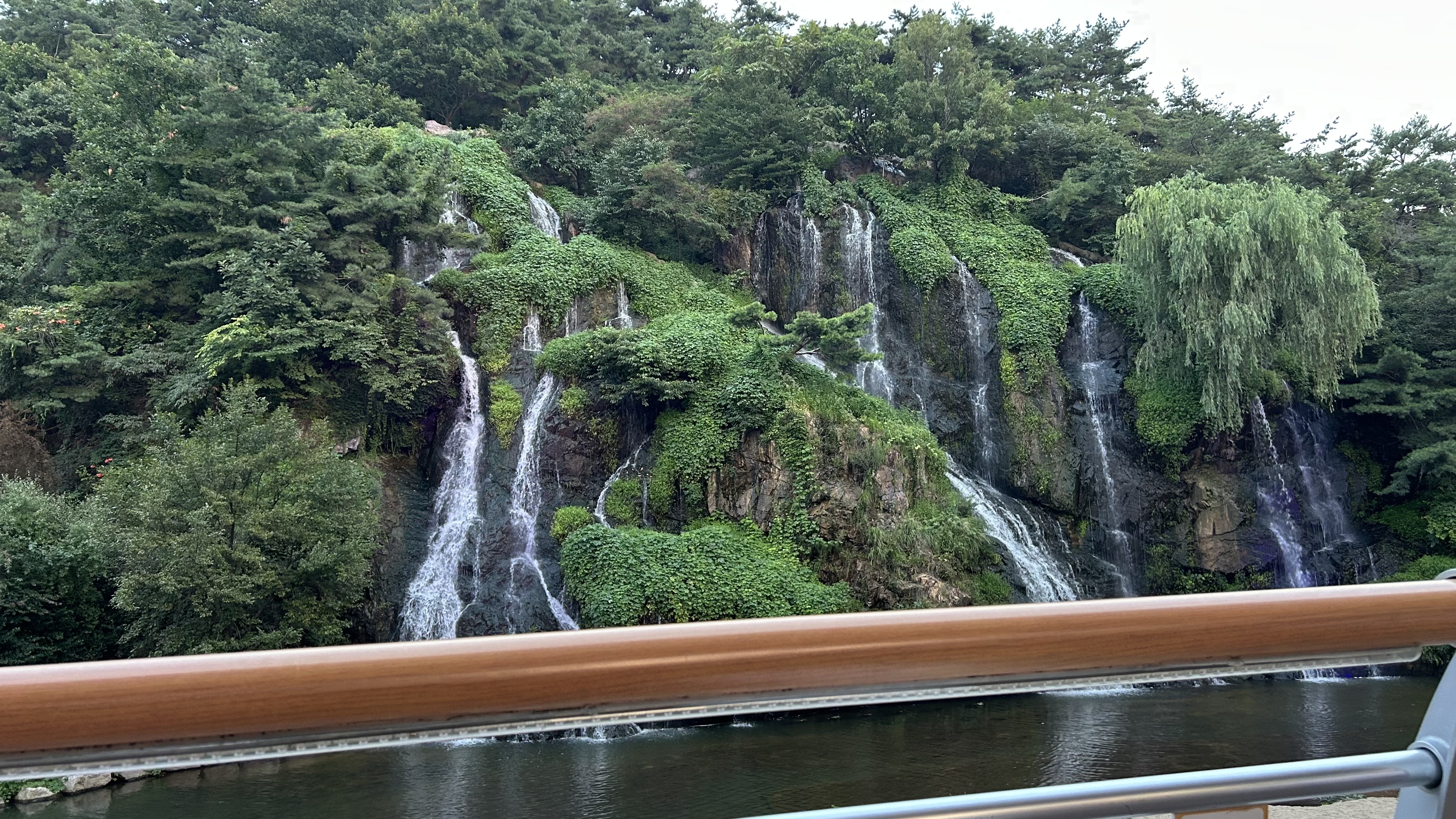 Cafe Pokpo waterfall illuminated at night beside Hongjecheon in Seoul