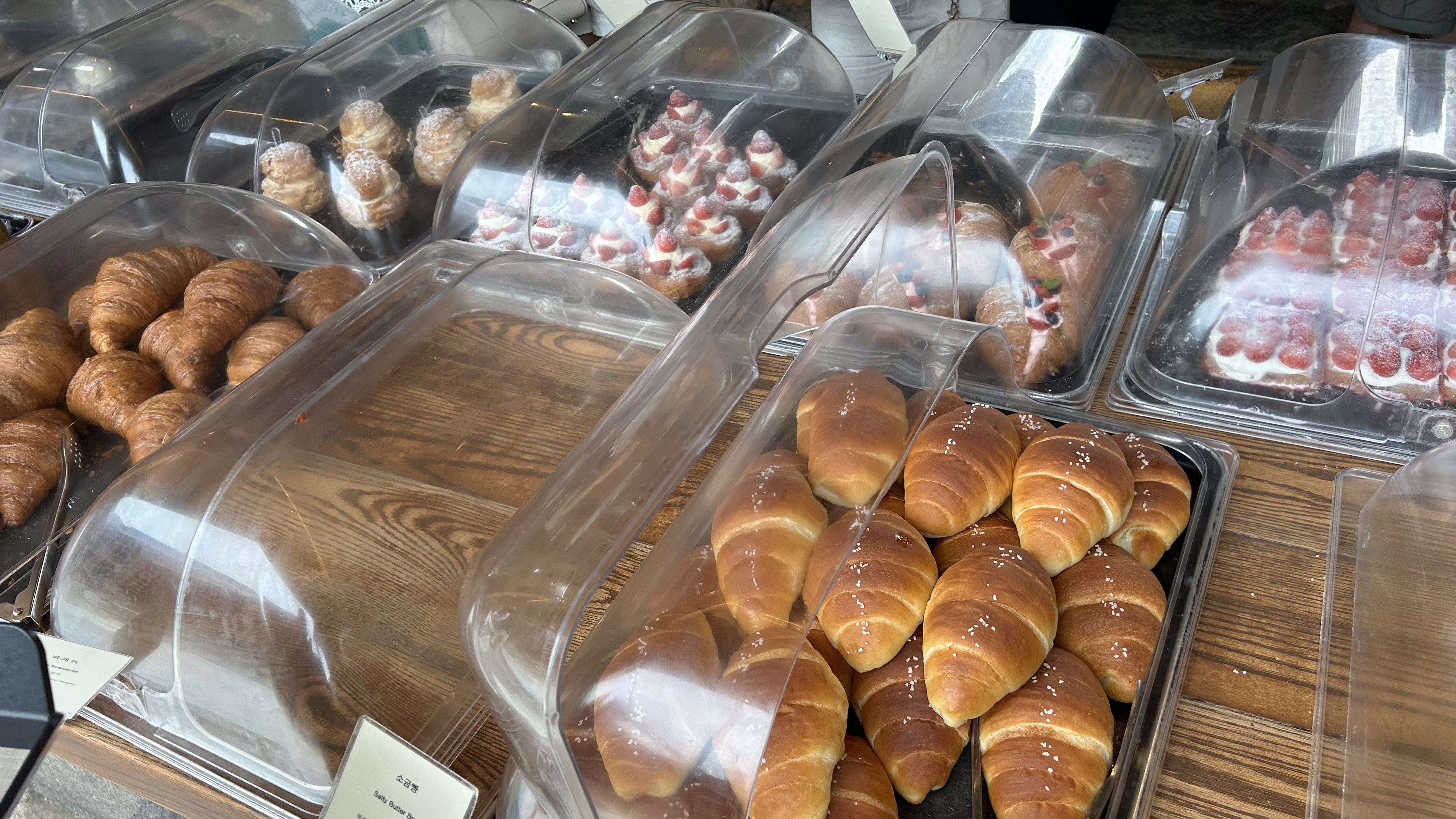 Cafe Onion Anguk table with Korean bakery breads and a view across the traditional hanok cafe